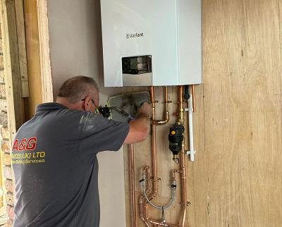 Plumber installing boiler in home